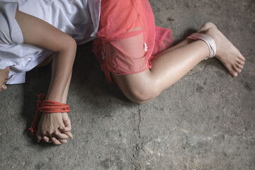 A victim tied up with rope. Stop violence against Women. International women's Day. Stop abusing...