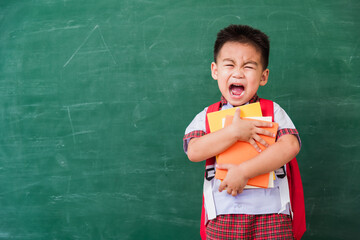 Back to School. Happy Asian funny cute little child boy from kindergarten in student uniform with...