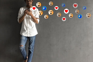 Social media concept with young man using smartphone with giving icon rating during  watching...