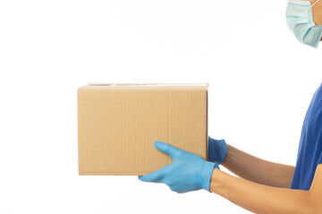 Delivery man hand in medical gloves and wearing mask holding cardboard boxes isolated on white background, Delivery service concept.