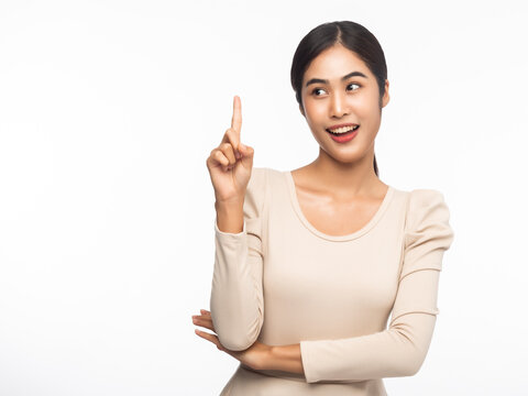 Portrait of young asian business woman pointing up isolated on white background.