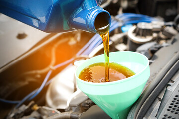 Refueling and pouring oil quality into the engine motor car Transmission and Maintenance Gear...