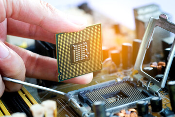 Hand of computer engineering brings computer cpu processor memory change components into socket...