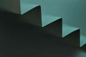 Wallpaper phone background. dark green zigzag abstract background.Sharp crankle surface.blurry...