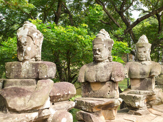 Fototapeta premium The ancient stone statue of Khmer god on the south gate of Angkor Thom, the world heritage site in Siem Reap province, Cambodia