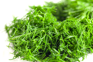 Chopped into small pieces dill isolated on white background, fresh dill