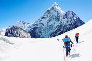 Group of climbers reaching the Everest summit in Nepal. Team work concept.