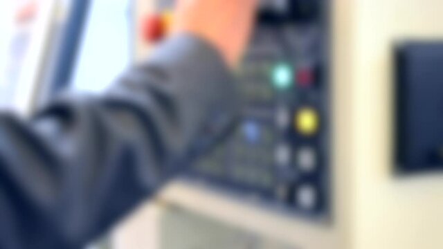 Person works behind the control panel of the production machine