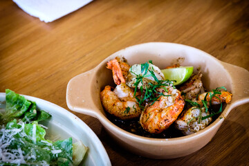 Grilled Gambas al Ajillo, Spanish chilli-and-garlic shrimp, served on a wooden table