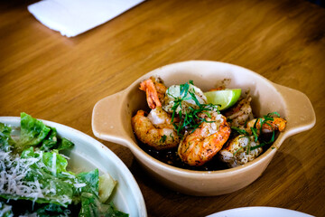 Grilled Gambas al Ajillo, Spanish chilli-and-garlic shrimp, served on a wooden table