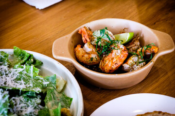 Grilled Gambas al Ajillo, Spanish chilli-and-garlic shrimp, served on a wooden table