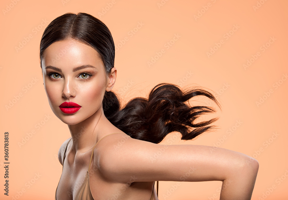 Wall mural beautiful white girl with a red lipstick on lips. stunning brunette girl with long hair tail. closeu