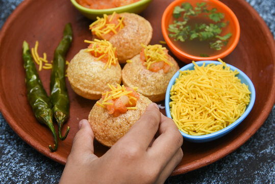 Spicy Pani puri golgappe and  potato stuffing, Chat item, India. panipuri, North Indian street food snack served with tangy tamarind water, chaat masala, chickpeas Delhi, Mumbai, Rajasthan, Bangalore