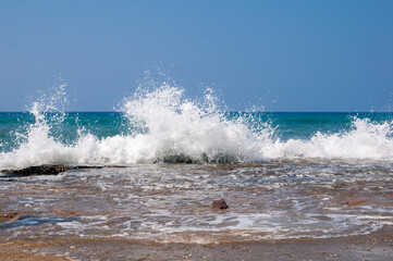 Sea waves close up shot, selective focus, white foam on the sea wave.