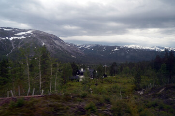 Fototapeta na wymiar Views from the train window. Mountain tundra of Central Norway. Railway travel in Norway.The Bergen - Oslo train.