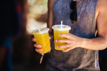 Fototapeta premium Man is holding sugar cane juice in hands.