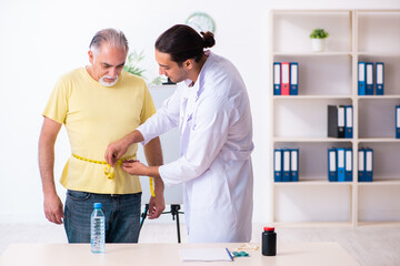 Fototapeta premium Doctor dietician giving advices to fat overweight patient