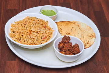 Chicken Biryani is a savory chicken and rice dish that includes layers of chicken, rice, and aromatics that are steamed together.