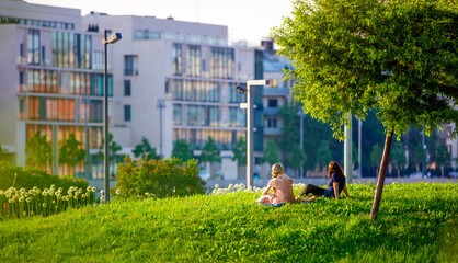 Couple relaxing on the grass in the city 