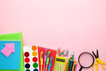 School supplies on pink background with copy space. Back to school. Flat lay.