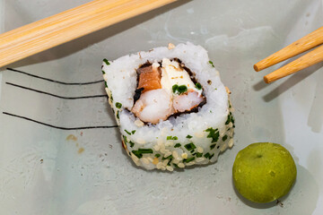 Japanese sushi food is excellent. Maki and rolls with tuna, salmon and avocado. Top view of sushi roll. wasabi.Selective focus.