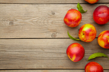 Many nectarines on grey wooden background with copy space