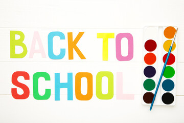 Watercolor paints set with inscription back to school on white background