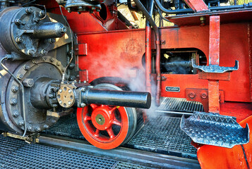 Detail of the technology of an antique red steam locomotive.