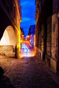 BIELSKO-BIALA, POLAND - APRIL 9, 2019: Night view of Bielsko Biala market square and cobbled narrow illuminated alleys. Poland