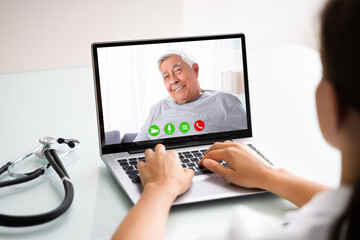 Obraz na płótnie Canvas Doctor Talking To Male Patient Through Video Chat