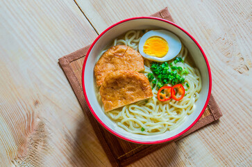 instant noodle with egg and fish plate.