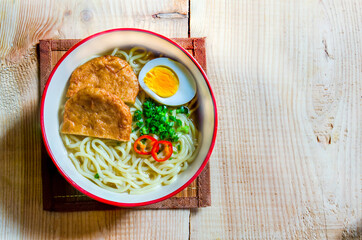 instant noodle with egg and fish plate.