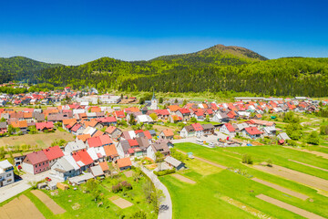 Croatia, town of Delnice, Gorski kotar, panoramic view of town center from drone in spring, mountain landscape in background