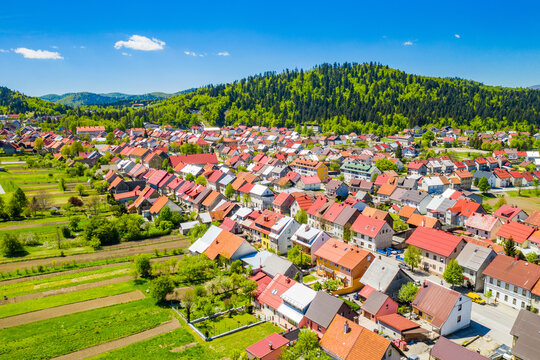 Croatia, town of Delnice, Gorski kotar, panoramic view of town center from drone in spring, mountain landscape in background