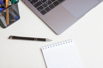 Blank notebook with laptop on office desk table. Concept of online work or education. Top view