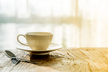A white coffee mug on a wooden office desk