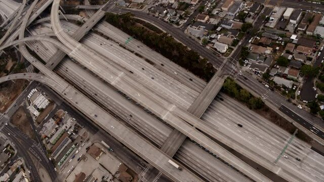 Aerial of freeways in Los Angeles, highway junction, top perspective, urban view, sunset in big city
