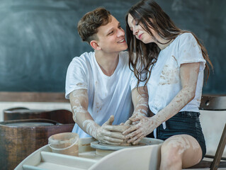 Beautiful young couple in a pottery workshop