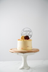 Birthday cake with macaroons on white background