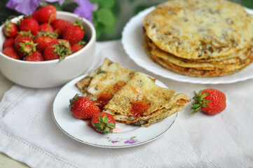Homemade pancakes and fresh strawberries