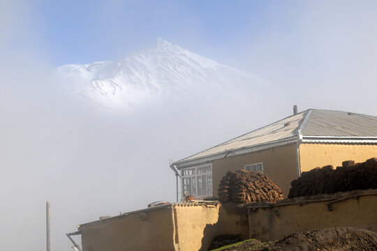 Kurush village (the southernmost point of Russia and the highest mountain settlement in Europe, 2560 m) and Mount Bazarduzu (4,467 m, the highest peak in Azerbaijan). Dagestan, North Caucasus, Russia.