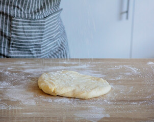 flour falls on the dough