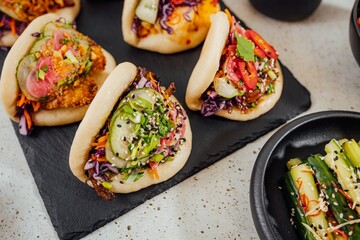 Closeup shot of steamed bao buns on a black surface