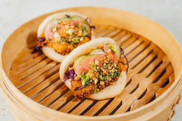Closeup shot of a steamed bao bun with meat and vegetables