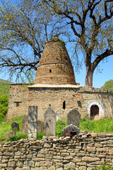 Medieval mausoleum and tombstones in Kala-Koreysh fortress. Dagestan, North Caucasus, Russia..