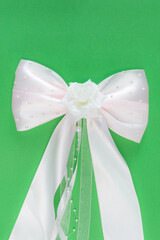 white bow on green background
