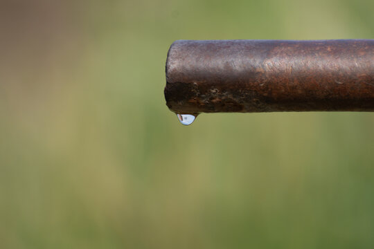Water drop from the old rusty pipe in the Thar desert