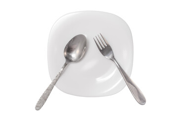 A spoon and fork lie on an empty white plate on a white background, isolated image