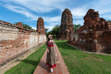 Asian women tourist traveling at wat Mahathat temple, Ayutthaya Province, Thailand