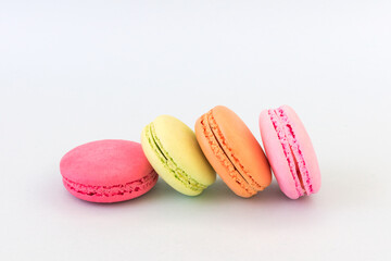 Colorful macarons on white background.